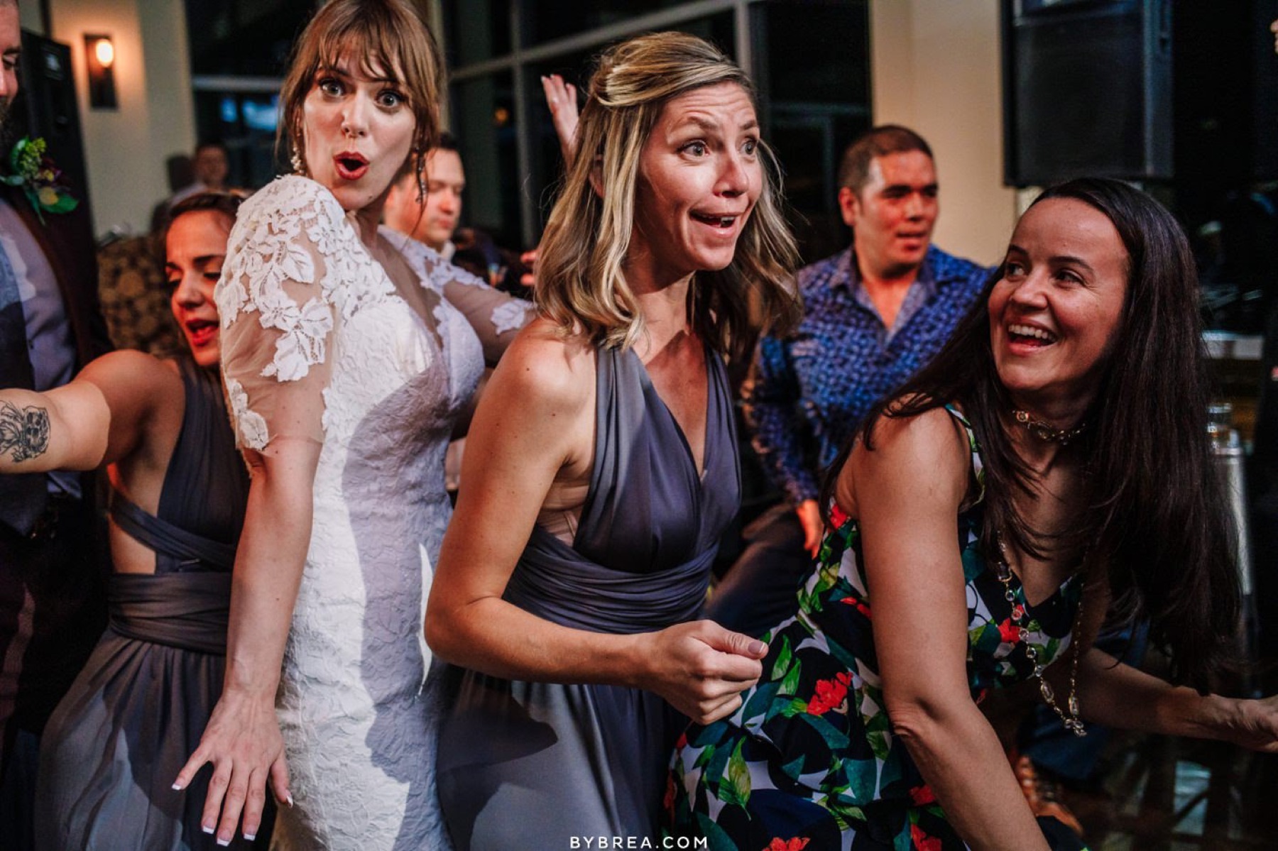 Bridesmaids singing along on the dance floor