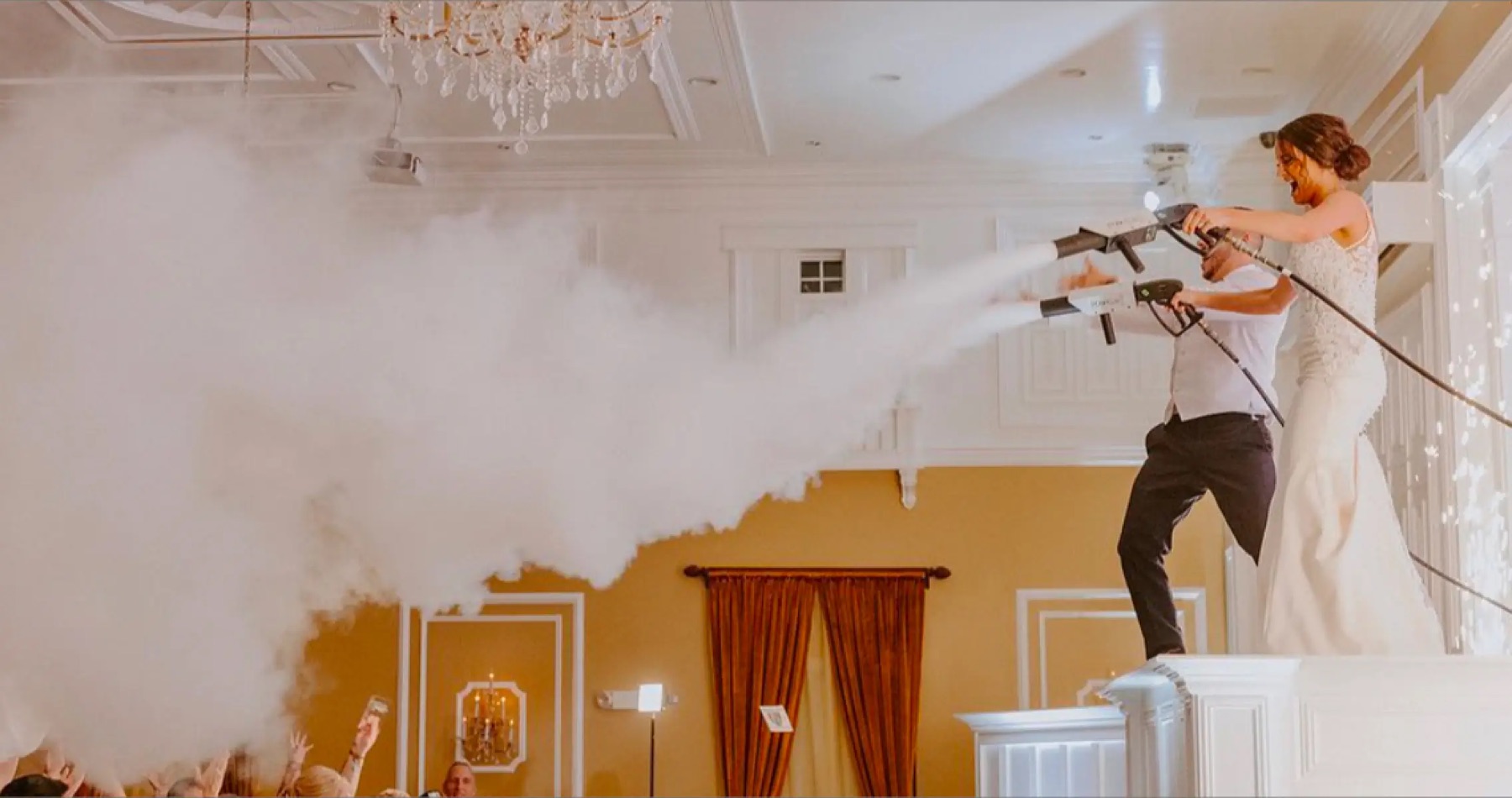 Newlyweds firing fog cannons over the dance floor