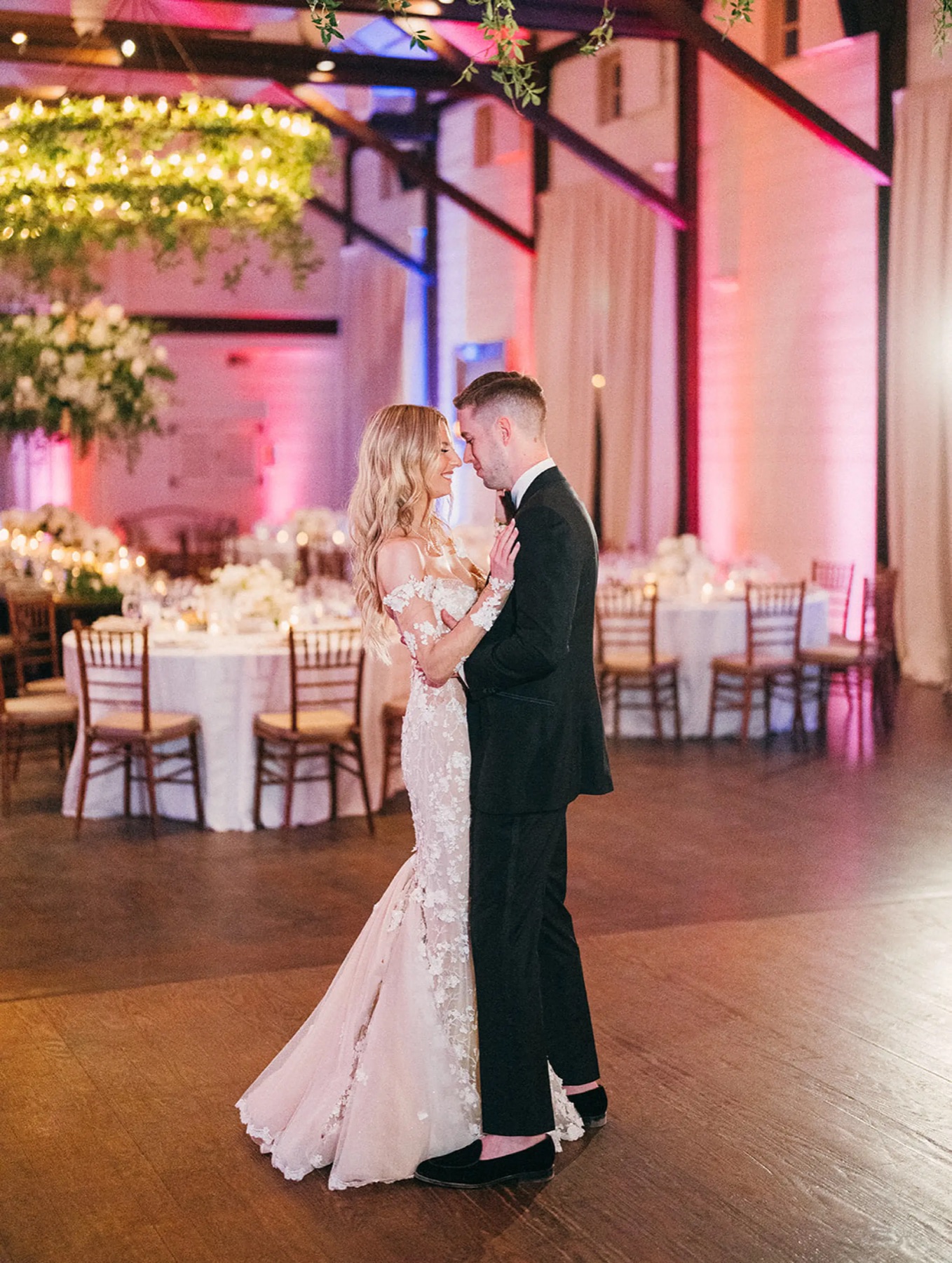 A first dance in a candlelit ballroom